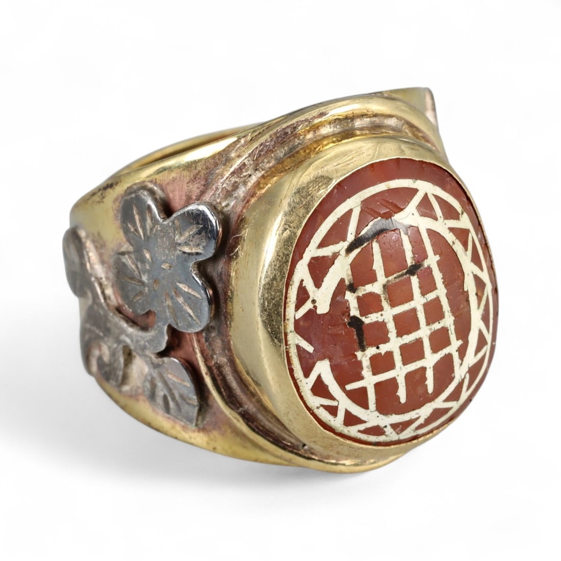 Antique Etched Carnelian Silver Gilt Ring, Early Stone, 20th Century Mount: This striking ring features an antique etched carnelian, its surface decorated with traditional linear motifs filled with gold, a style associated with ancient talismanic seals and amulets. The carnel