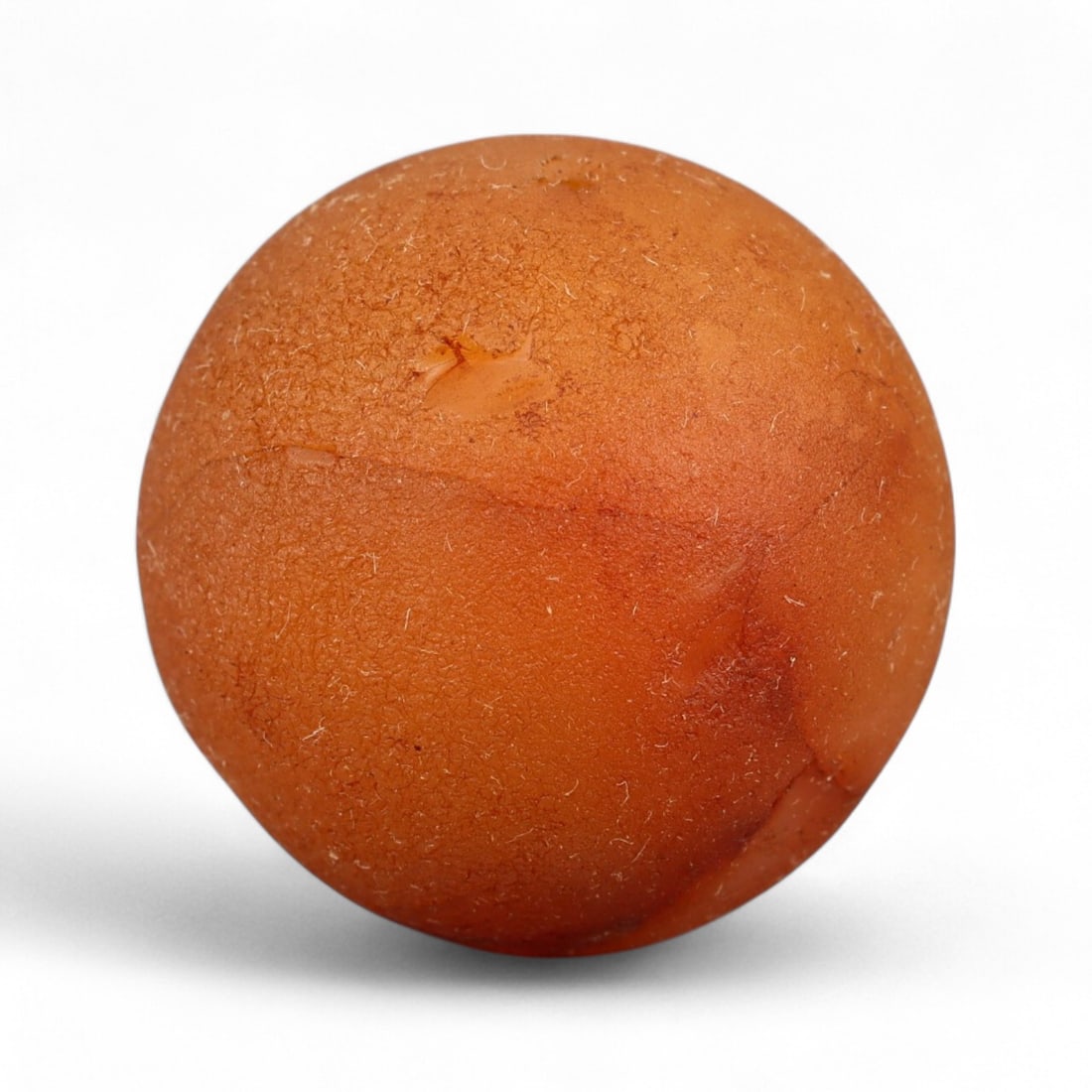 Antique Tibetan Carnelian Mala Prayer Bead, c. 18th-19th Century, 2.2cm: This antique carnelian mala bead originates from the Himalayan cultural sphere, most likely 18th-19th century Tibet, a period when devotional craftsmanship flourished under the influence of both Buddh