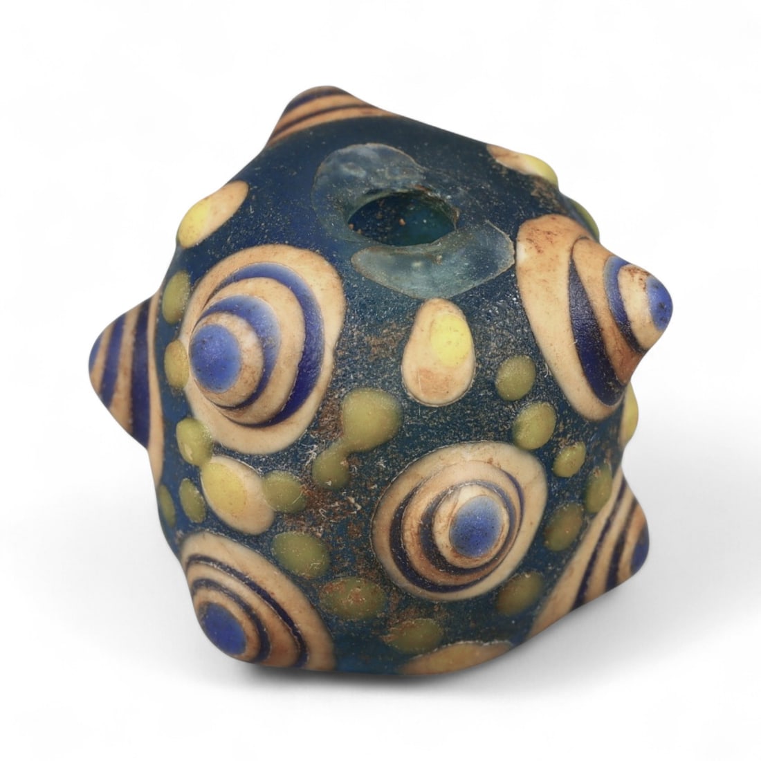 Ancient Western Asiatic Eye Mosaic Glass Bead, c. 4th-2nd Century BCE, 1.6cm: This finely crafted mosaic glass bead, originates from Western Asia and dates to the 4th-2nd century BCE. Beads of this type, often referred to as "eye beads," were highly valued across the ancient Me