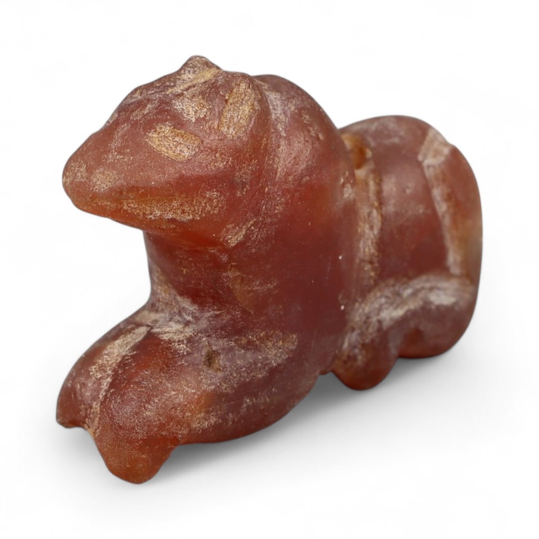 Ancient Coptic Egyptian Carnelian Feline Amulet, c. 5th-7th Century CE, 2.1cm: This finely carved amulet, depicts a feline, sculpted in warm reddish-brown carnelian with lighter mineral veining. Created during the Coptic Egyptian period, c. 5th-7th century CE, it reflects the co
