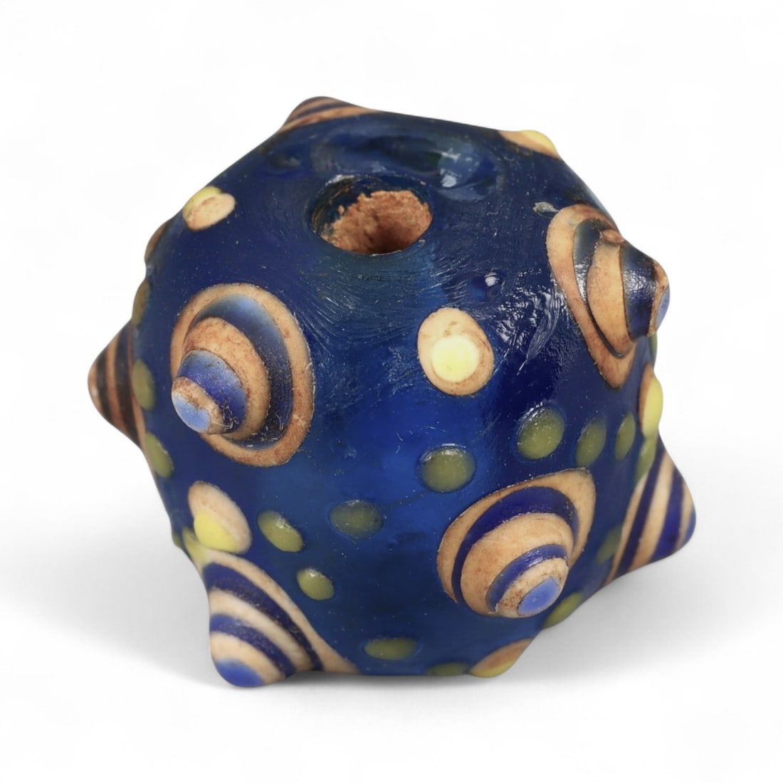 Ancient Western Asiatic Eye Mosaic Glass Bead, c. 4th-2nd Century BCE, 1.7cm: This finely crafted mosaic glass bead, originates from Western Asia and dates to the 4th-2nd century BCE. Beads of this type, often referred to as "eye beads," were highly valued across the ancient Me