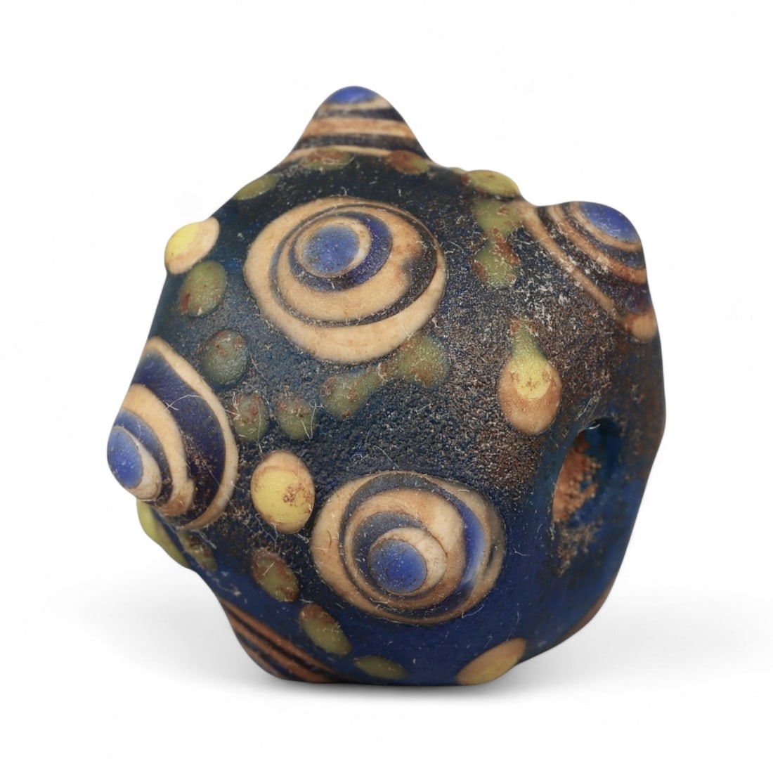 Ancient Western Asiatic Eye Mosaic Glass Bead, c. 4th-2nd Century BCE, 1.8cm: This finely crafted mosaic glass bead, originates from Western Asia and dates to the 4th-2nd century BCE. Beads of this type, often referred to as "eye beads," were highly valued across the ancient Me