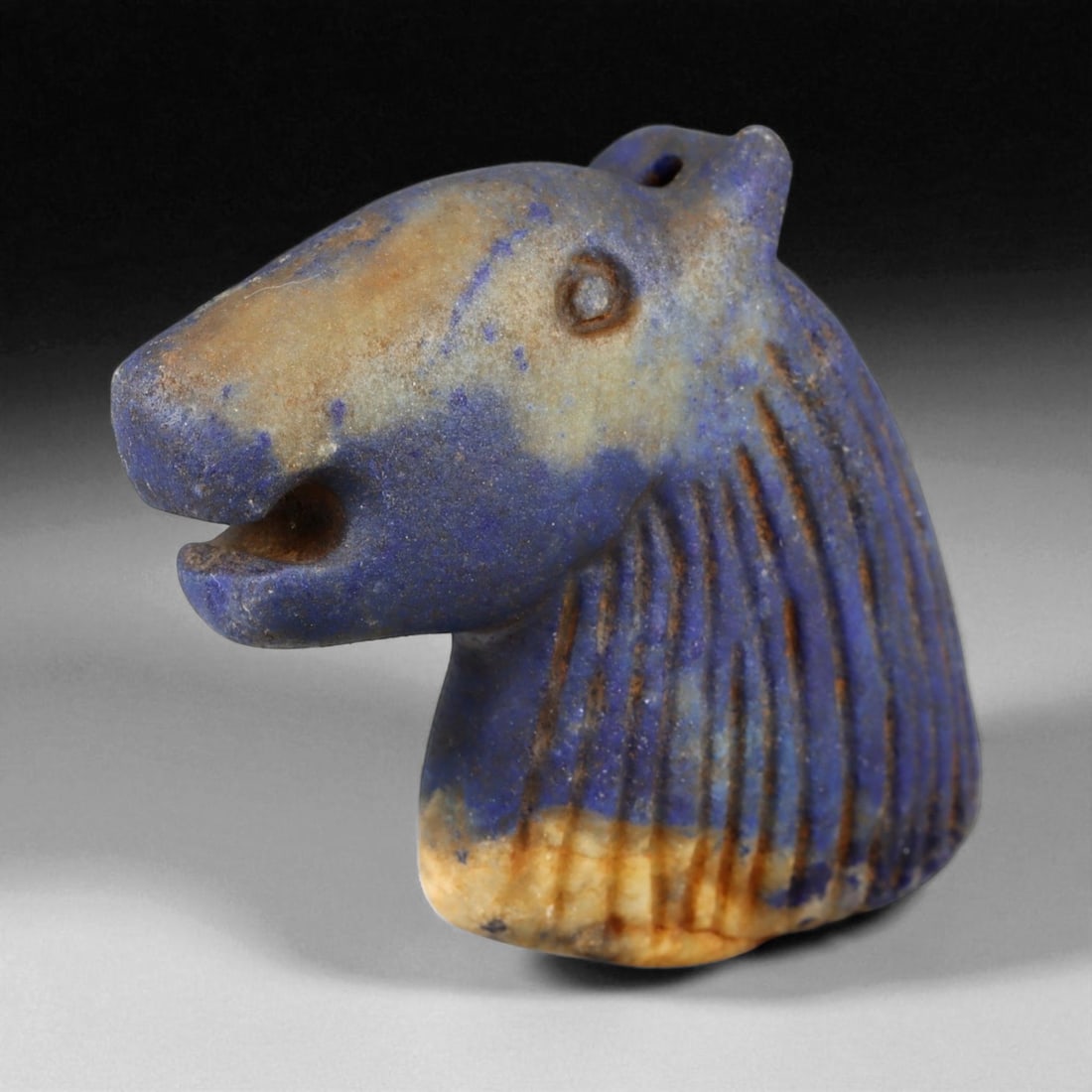 Ancient Bactrian Lapis Lazuli Horse Bust Amulet, c. 2nd-1st Millennium BCE, 6cm: This beautifully carved lapis lazuli horse bust amulet originates from ancient Bactria, circa 2nd-1st millennium BCE - a region celebrated for its mastery of stone carving and for serving as a vital c