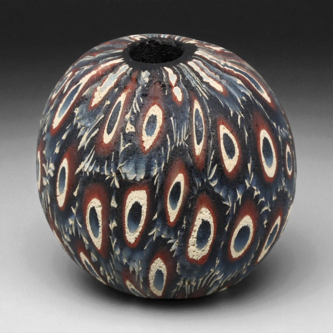Antique Majapahit Borneo Glass Trade Bead, Southeast Asia, c. 13th-16th Century CE, 2.1cm: This antique glass bead originates from the cultural sphere of the Majapahit era, a flourishing maritime kingdom that once linked Java, Borneo, and much of Southeast Asia through extensive trade and a