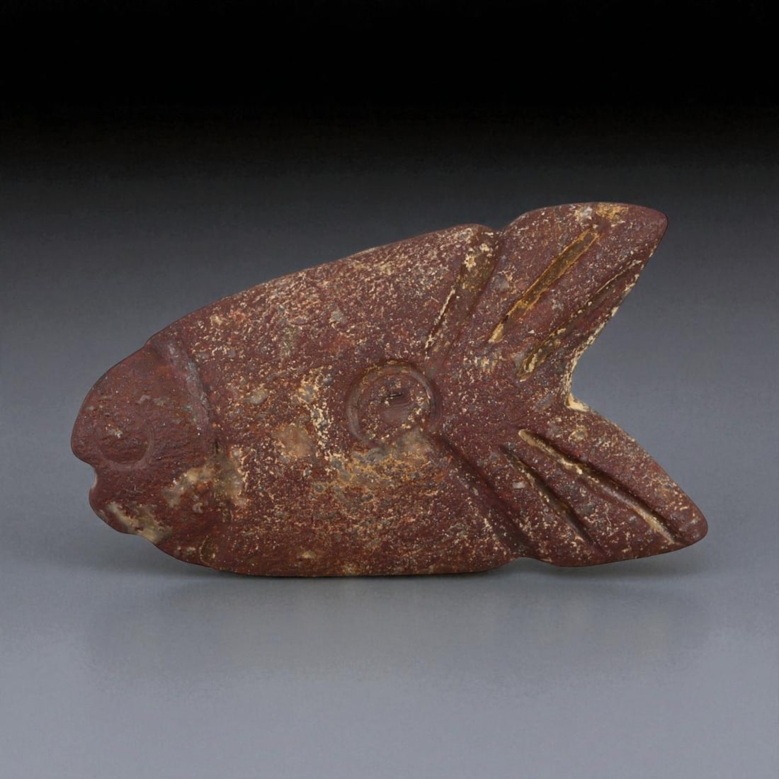 Ancient Indus Valley Red Jasper Fish Amulet, c. 2600-1900 BCE, 2.6cm: This finely carved red jasper amulet, depicting a stylized fish, originates from the Indus Valley Civilization, one of the earliest centers of urban and artistic achievement in human history (c. 2600-
