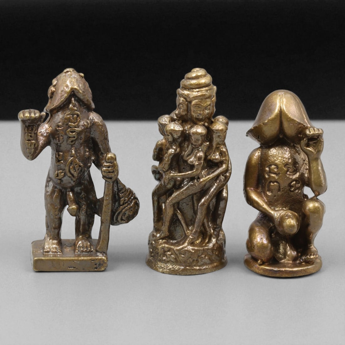 Vintage Thai Tantric Protective Bronze Amulet Trio, c. 20th Century, 3cm: This rare trio of vintage Thai bronze amulets embodies the mystical dimension of spiritual protection and tantric symbolism in Southeast Asian esotericism. Each finely cast piece in copper-bronze allo