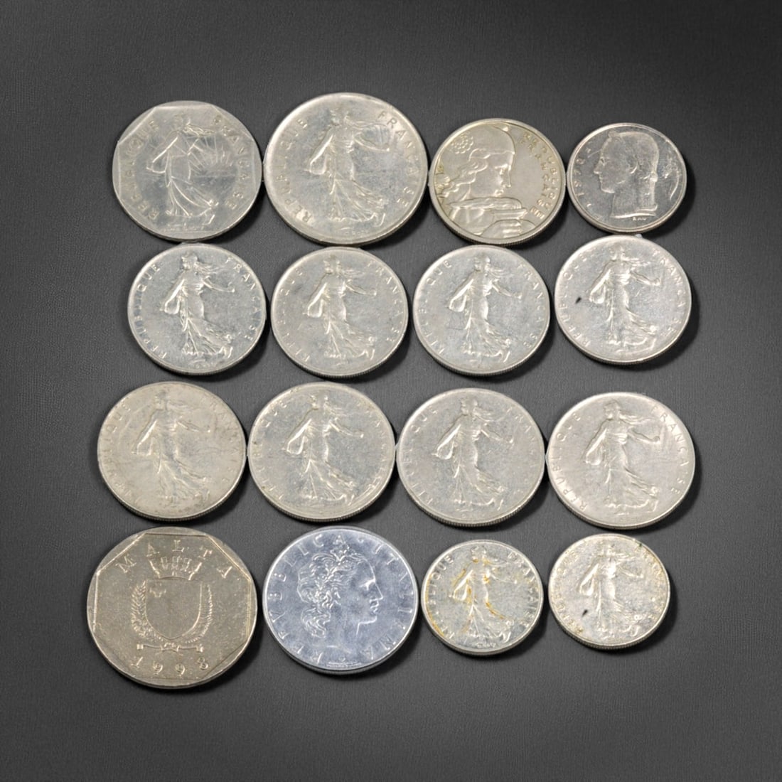 FRANCE: Marianne & Modernism - Silver-Age Franc Coin Lot, 1950s-1990s: This 16-coin lot from the French Fifth Republic encapsulates the evolving visual and ideological symbolism of postwar France. Dominating the obverse is Marianne, the national embodiment of liberty and