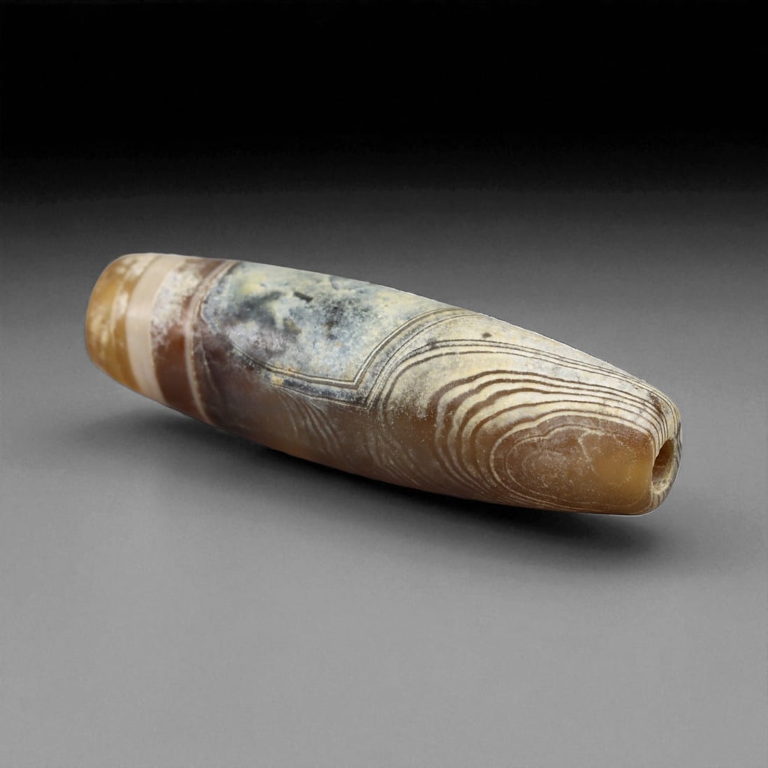 Ancient Persian Banded Agate Bead, Parthian-Roman Period c. 1st-3rd Century CE, 2cm, 1g: This elegant banded agate bead, originates from Persia during the Parthian-Roman cultural horizon of the 1st-3rd century CE. Agate, with its natural striations and layered beauty, was one of the most