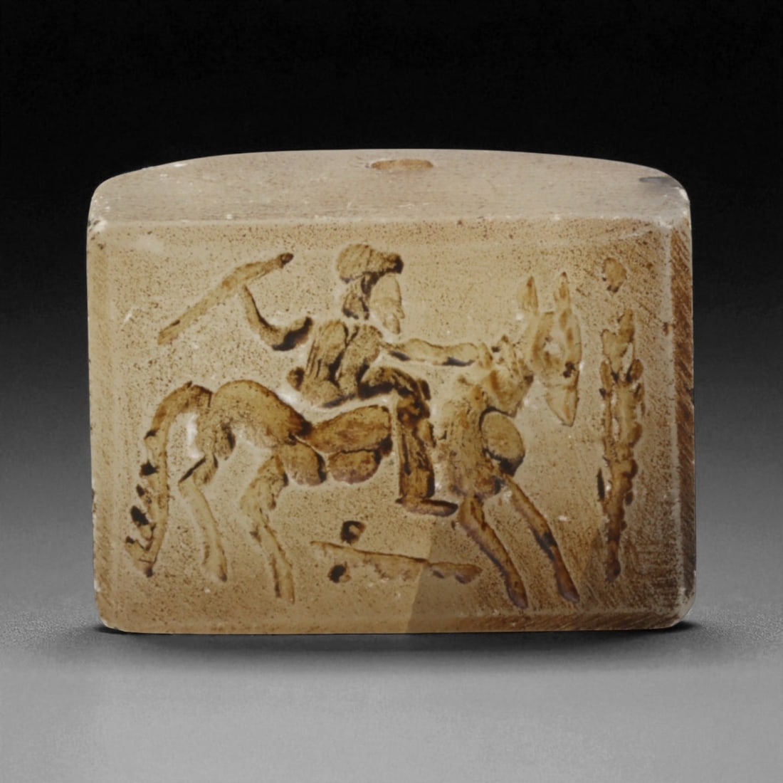 Ancient Sasanian Chalcedony Block Stamp Seal with Mounted Horseman, c. 3rd-6th Century CE, 62g: This robust chalcedony block stamp seal, weighing 62 grams and measuring 4 x 2.5 cm, originates from the Sasanian Empire (c. 224-651 CE). The engraving portrays a mounted horseman, depicted mid-action