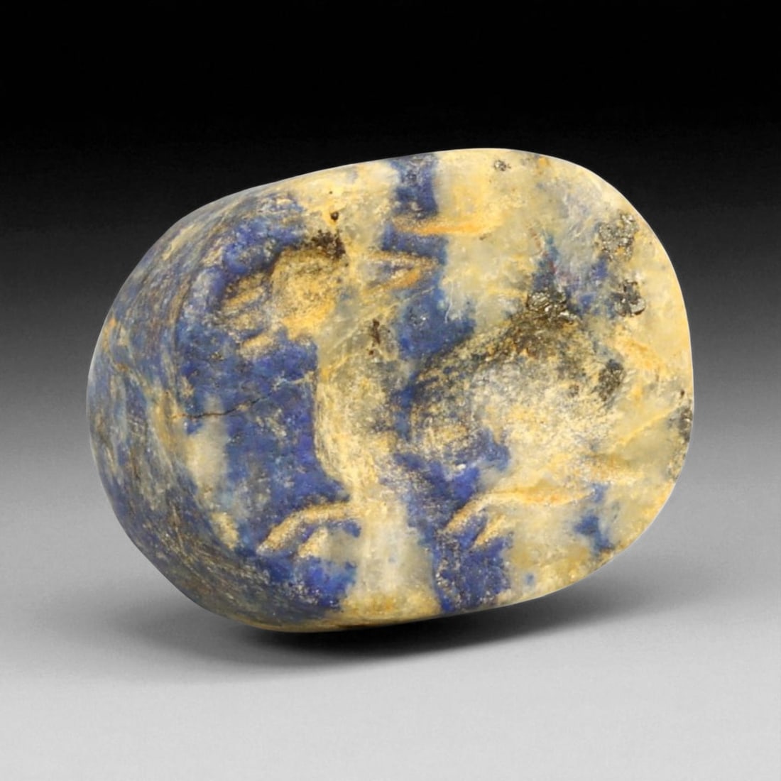 Ancient Elamite Reclining Ibex Motif Lapis Lazuli Stamp Seal, c. 2500-1800 BCE - 13g: This beautifully preserved Elamite stamp seal, hand-carved from celestial lapis lazuli, showcases a finely composed reclining ibex-an enduring emblem of vitality, protection, and divine favor in ancie