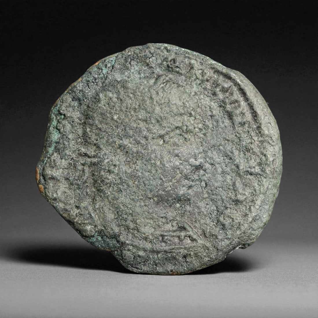 ROMAN EMPIRE: Imperial Authority - Bronze Coin, c. 1st-3rd Century AD, 18mm: Struck during the turbulent decades of the later Roman Empire, this 19mm bronze coin reflects the enduring symbolism of imperial control amidst crisis. Its compact yet deliberate design likely feature