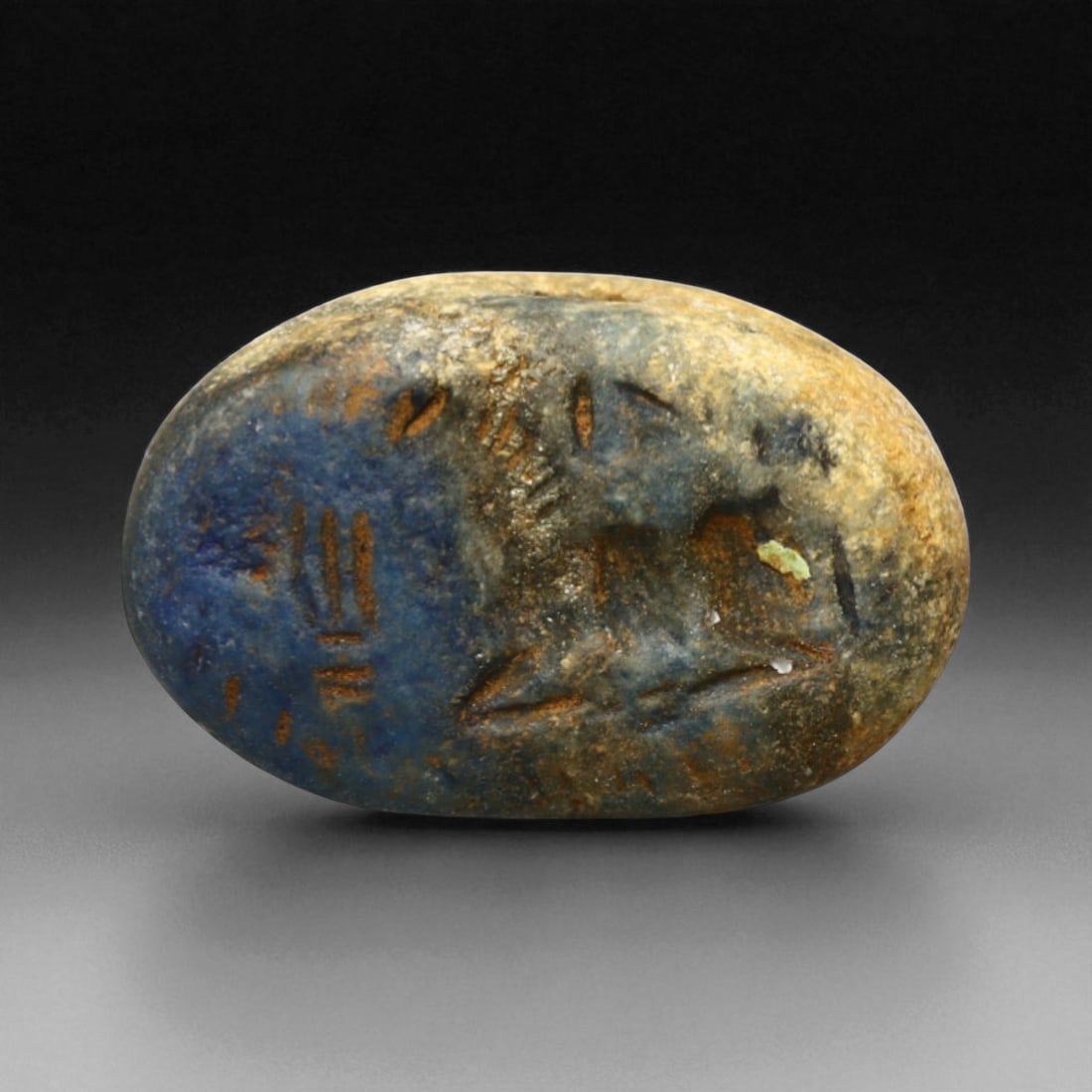 Ancient Elamite Reclining Caprid Motif Oval Lapis Lazuli Stamp Seal, c. 2500-1800 BCE, 9.35g: This elegant oval stamp seal, carved in deep blue lapis lazuli, reflects the sophisticated symbolism of the Elamite-Indus interaction period, c. 2500-1800 BCE. The seal's imagery shows a reclining cap