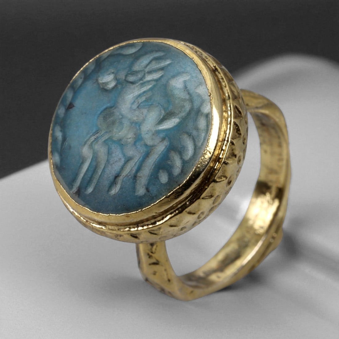 Antique Qajar Gold Gilt Intaglio Signet Ring, c. 19th-20th Century, 9 US, 16g: This substantial gilt ring, dating to the Qajar era of the 19th-20th century, embodies the regal aesthetic and cultural refinement of Persian jewelry traditions. The bezel is set with an engraved inta