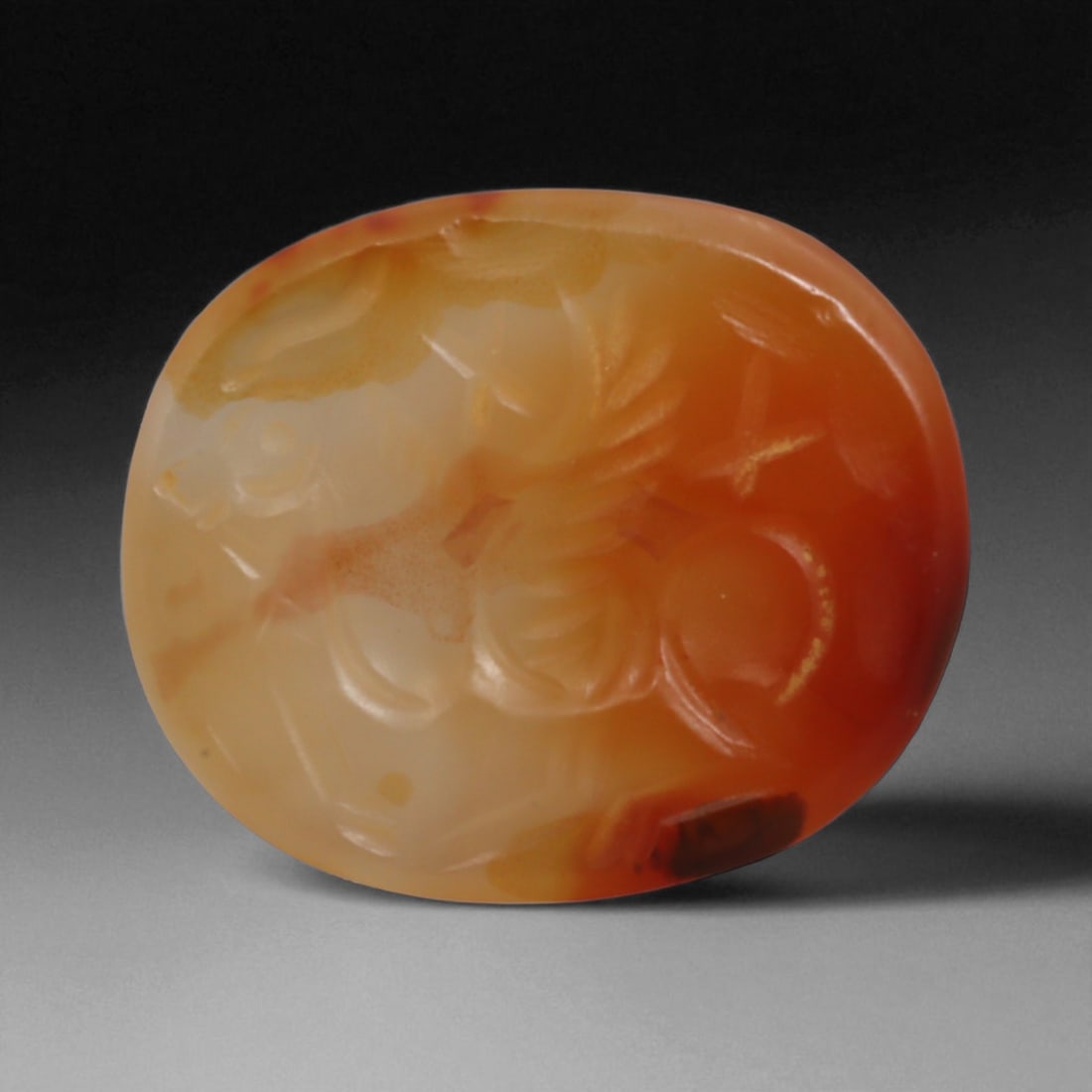 Ancient to Medieval Carnelian Intaglio Gemstone, c. 1st-18th Century CE, 2cm, 2g: This carnelian intaglio, finely engraved into the warm red tones of semi-precious stone, reflects a tradition of craftsmanship spanning from the classical world to the early modern era. Intaglios serv