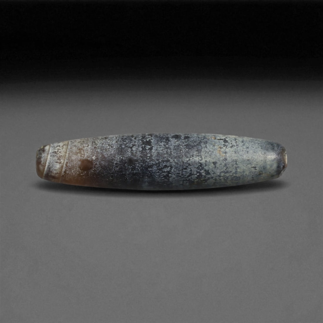 Ancient Persian Banded Agate Bead, Parthian-Roman Period c. 1st-3rd Century CE, 2.3cm, 1g: This elegant banded agate bead, originates from Persia during the Parthian-Roman cultural horizon of the 1st-3rd century CE. Agate, with its natural striations and layered beauty, was one of the most