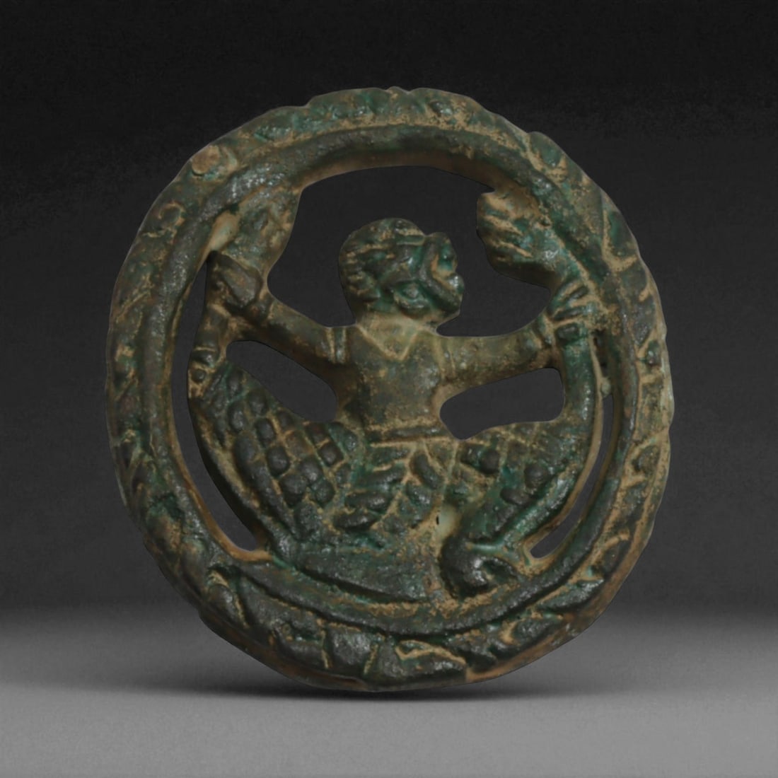 Antique Thai Garuda Medallion Amulet in Bronze-Copper Alloy, Rattanakosin Era, c. 19th Century CE,: This dynamic openwork medallion amulet features the mythical Garuda-half-man, half-eagle-presented mid-flight within a circular wreath border. Garuda, the celestial mount of Vishnu, is a powerful figu