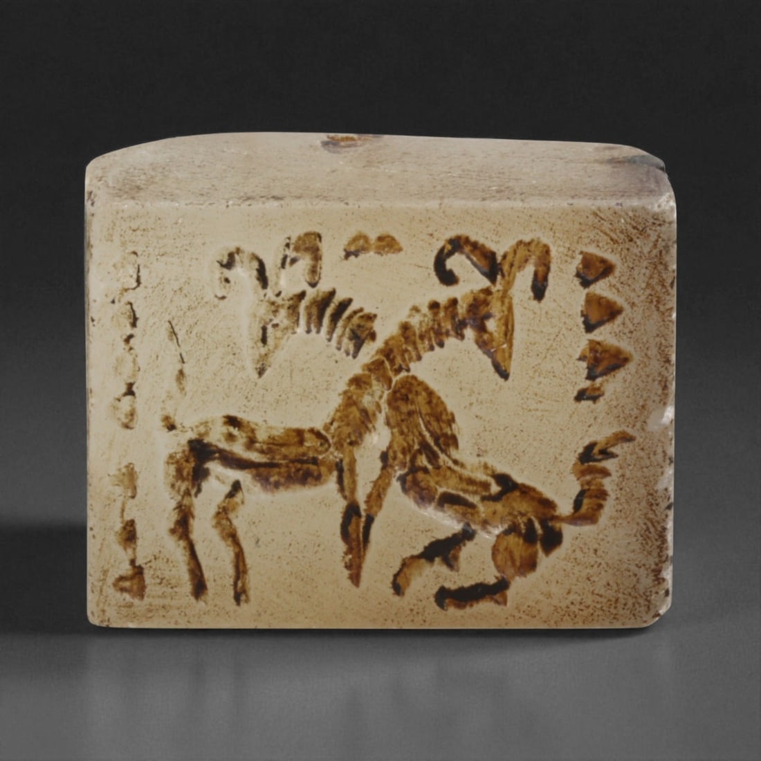 Ancient Sasanian Chalcedony Block Stamp Seal with Ibex Combat Scene, c. 3rd-6th Century CE, 67g: This finely crafted chalcedony block stamp seal, measuring 4 x 2.5 cm and weighing 67 grams, dates to the Sasanian Empire (c. 224-651 CE). The carving depicts a dynamic ibex combat scene, with two hor