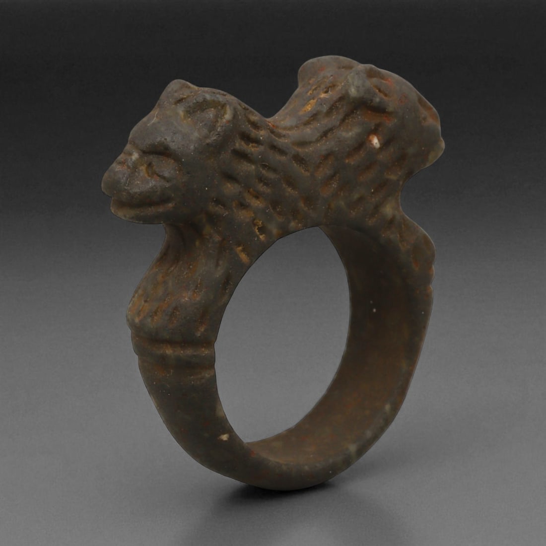 Ancient Mesopotamian Double-Lion Steatite Ring, c. 2nd Millennium BCE, 3.4 cm: This powerful stone ring, sculpted in steatite with twin lion heads, originates from the cultural heartlands of ancient Mesopotamia during the 2nd millennium BCE-a period marked by the flourishing of 