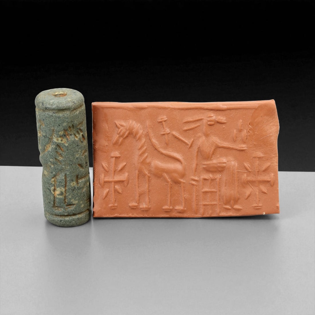 Ancient Akkadian Seated Deity and Equid Motif Chlorite Cylinder Seal, c. 2350-2150 BCE, 4.4 cm: This exceptional cylinder seal, carved from smooth green chlorite, originates from the Akkadian Empire (circa 2350-2150 BCE), one of Mesopotamia's most artistically advanced and historically significa