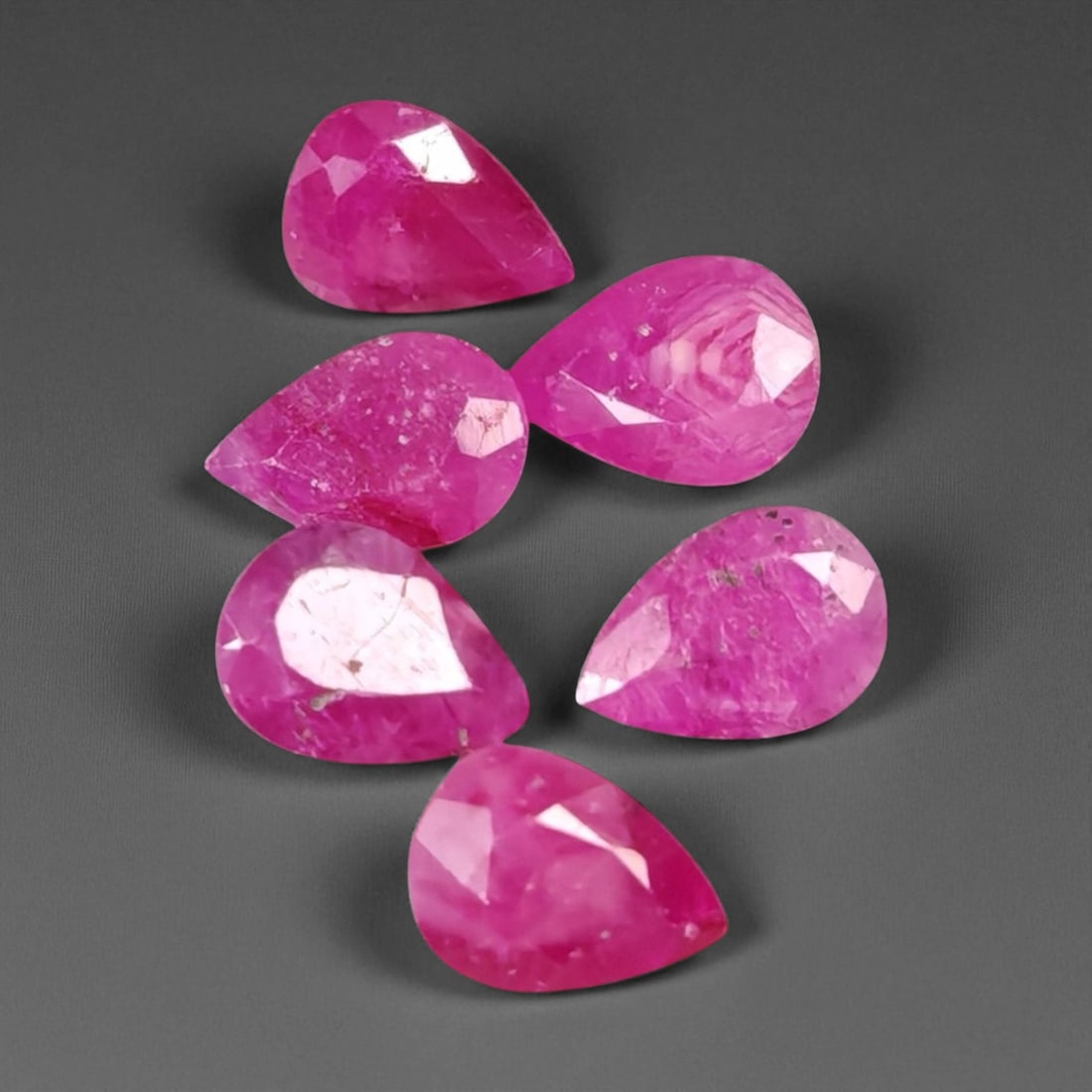 4.87 Carats Vivid Pinkish Red Ruby Pear Lot - Natural Mozambique Stones: This lively lot of ruby pear glows with an intense pinkish-red tone that captures the eye with warmth and vibrancy. Each gem, measuring approximately 6.8x4.9x3.3mm, reveals a balance of medium to deep