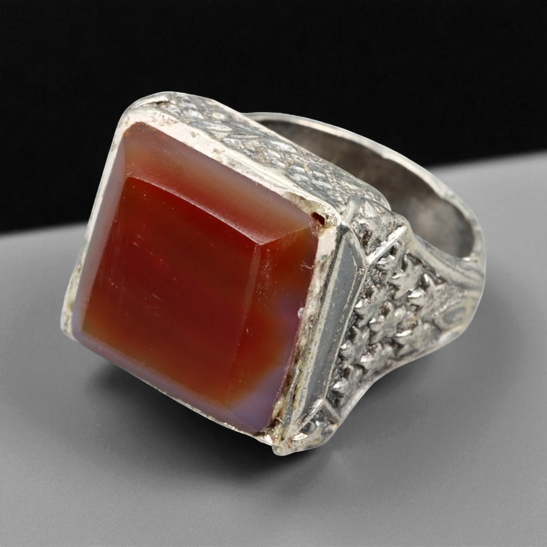 Antique Persian Carnelian Intaglio-Style Silver Ring, c. 19th-20th Century, US Size 9.75: This stately antique silver ring embodies the elegance and symbolic depth of Persian craftsmanship from the late Qajar to early Pahlavi era. The centerpiece is a rich, deep-orange carnelian cut into a