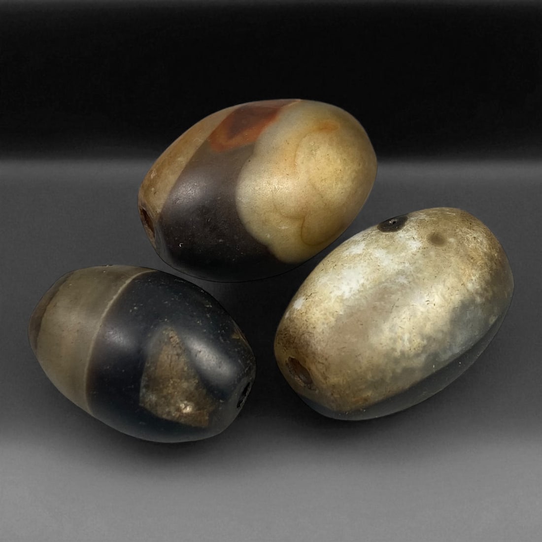 Antique Himalayan Dzi-Style Agate Beads, 3pcs, c. 18th-19th Century, 2.5-2.9 cm: This refined trio of antique agate beads reflects the enduring spiritual and aesthetic legacy of Himalayan craftsmanship from the 18th-19th century. Each bead, hand-polished from banded agate, display