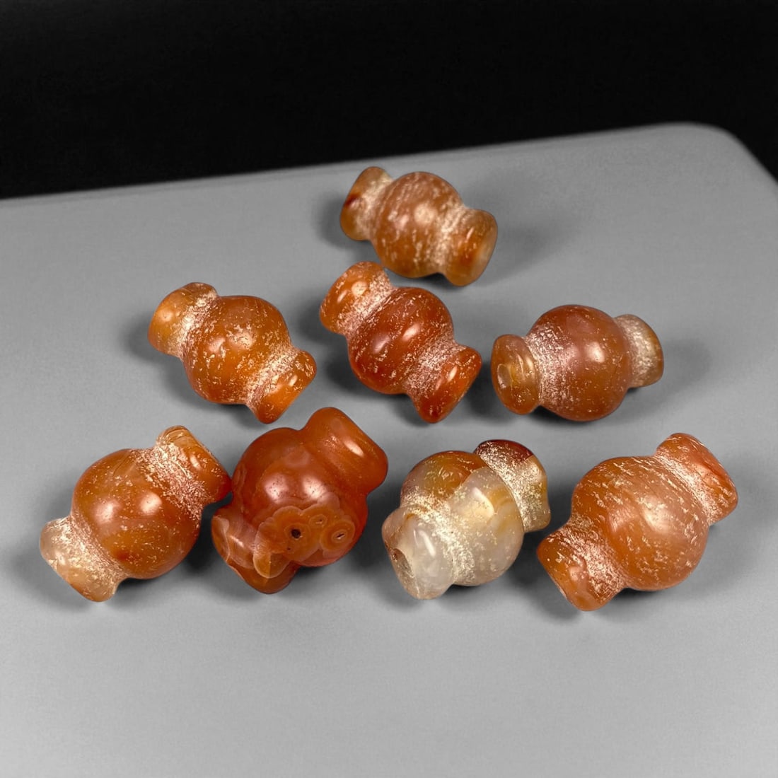 Ancient Medieval Chola Collared Carnelian Trade Beads, c. 9th-13th Century CE, 2 cm (8 pcs): This set of eight collared carnelian trade beads originates from the Chola period of Southern India, dating to approximately the 9th-13th century CE. The Chola Empire, known for its expansive maritime