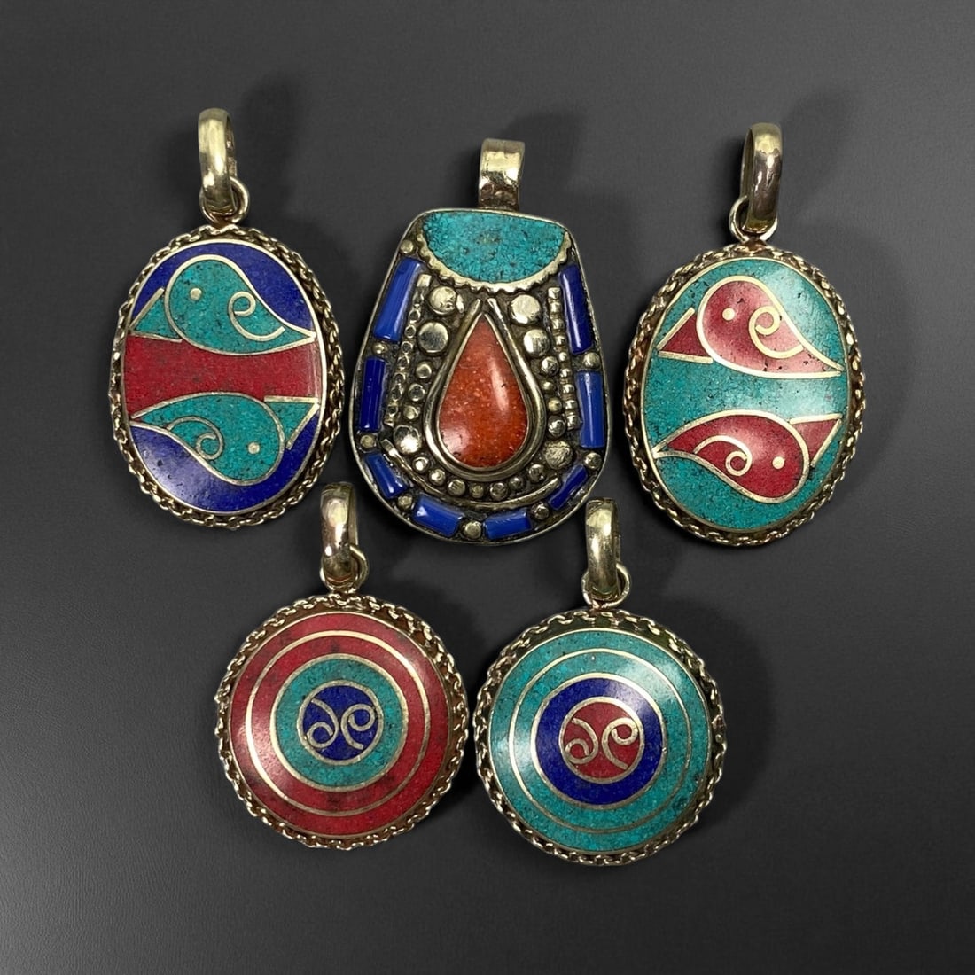 Vintage Himalayan Tribal Pendants, Lot of 5, c. 20th Century, 3-4 cm: These vintage Himalayan pendants capture the spirit and artistry of traditional jewelry from the highlands of Tibet and Nepal. Crafted with vibrant inlay work and detailed metal framing, they exemplif