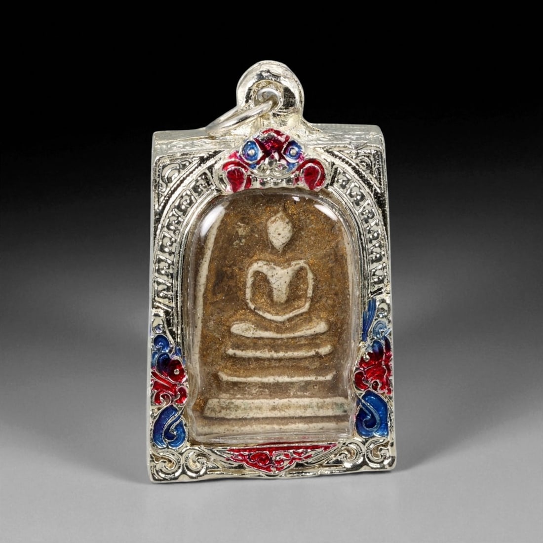 Antique Thai Rattanakosin Somdej Buddha Silver-Tone Enamel Amulet Pendant, c. 19th Century CE, 70g: This striking 19th-century Thai amulet from the Rattanakosin era presents the revered image of the Buddha in the iconic Phra Somdej style-seated in serene meditation atop a stylized triple-tiered base