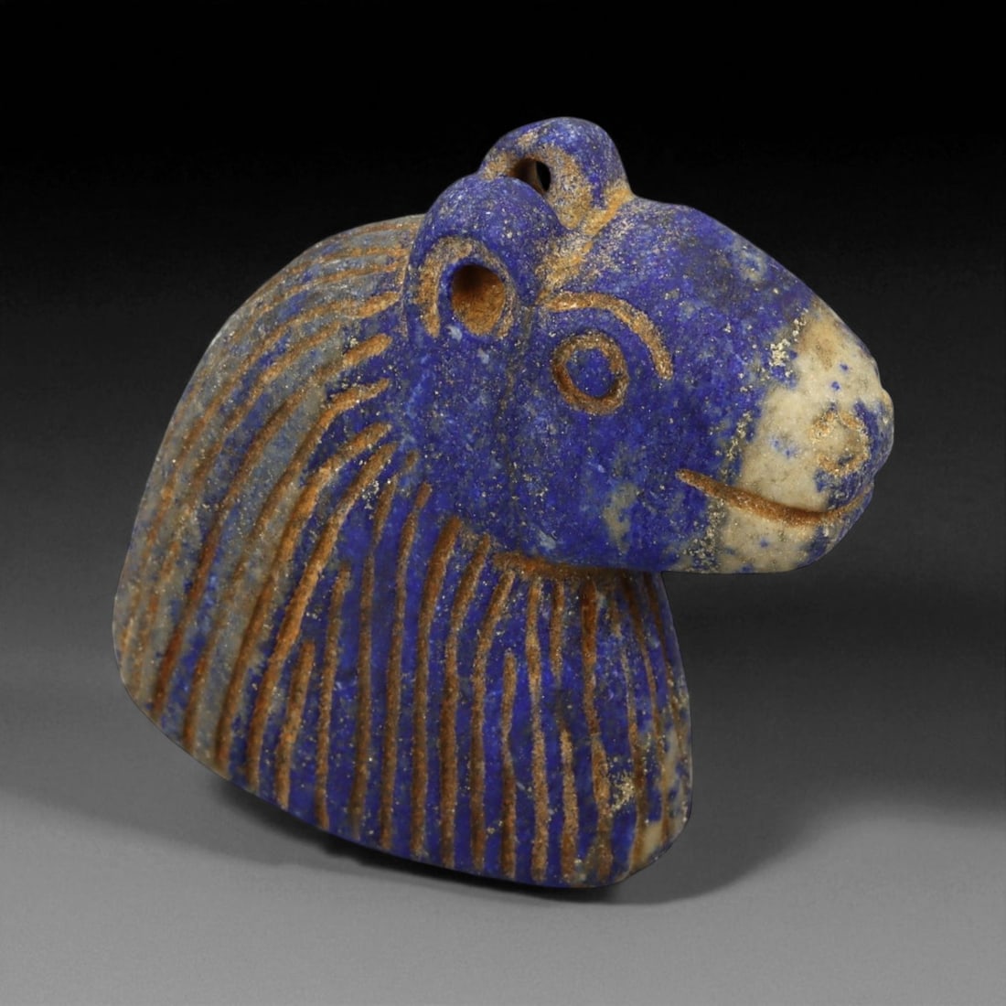 Ancient Bactrian Lapis Lazuli Horse Bust Amulet, c. 2nd-1st Millennium BCE, H 5cm: This beautifully carved lapis lazuli horse bust amulet originates from ancient Bactria, circa 2nd-1st millennium BCE - a region celebrated for its mastery of stone carving and for serving as a vital c