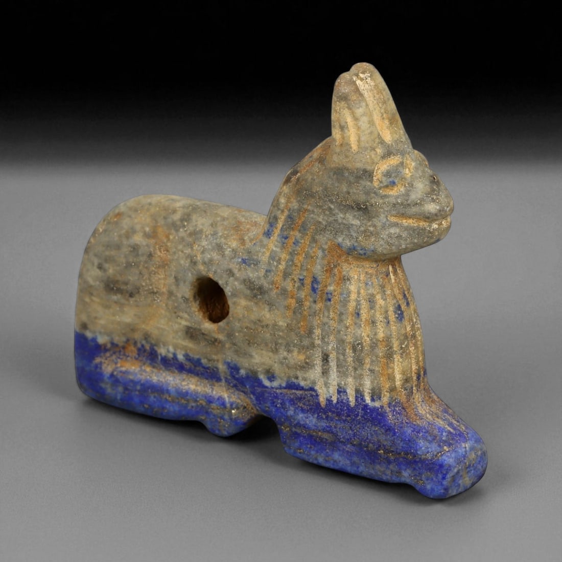 Ancient Bactrian Lapis Lazuli Lion Effigy, c. 2nd-1st Millennium BCE, 6cm: This striking lapis lazuli effigy, carved in the form of a recumbent lion, originates from ancient Bactria, circa 2nd-1st millennium BCE. Sculpted from vibrant blue lapis lazuli streaked with veins of