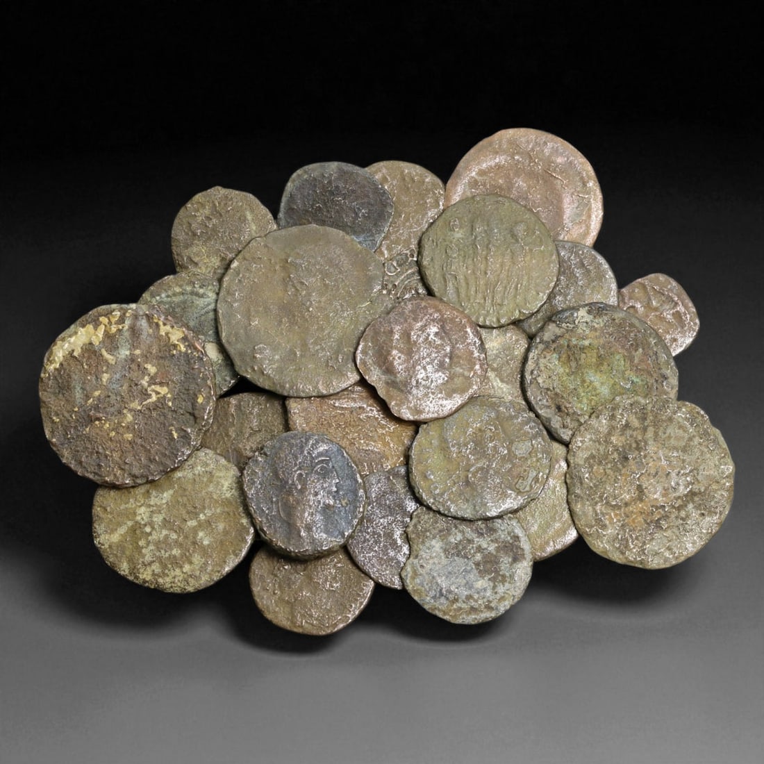 Ancient Roman Bronze Coins Lot, AE3 and AE4, c. 3rd-5th Century CE, 25 Coins: This lot of 25 bronze coins represents the currency of the late Roman Empire, spanning the 3rd to 5th centuries CE. These pieces, known as AE3 and AE4 denominations, were the small change of the Roman