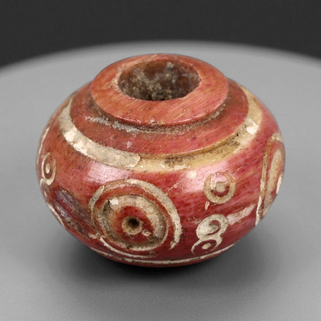 Ancient Medieval Nishapur Silk Road Bone Spindle Whorl, c. 9th-11th Century CE, 1.4cm: This finely carved spindle whorl originates from Nishapur, an important Silk Road city in medieval northeastern Iran, dating to approximately the 9th-11th century CE. Such spindle whorls were essentia