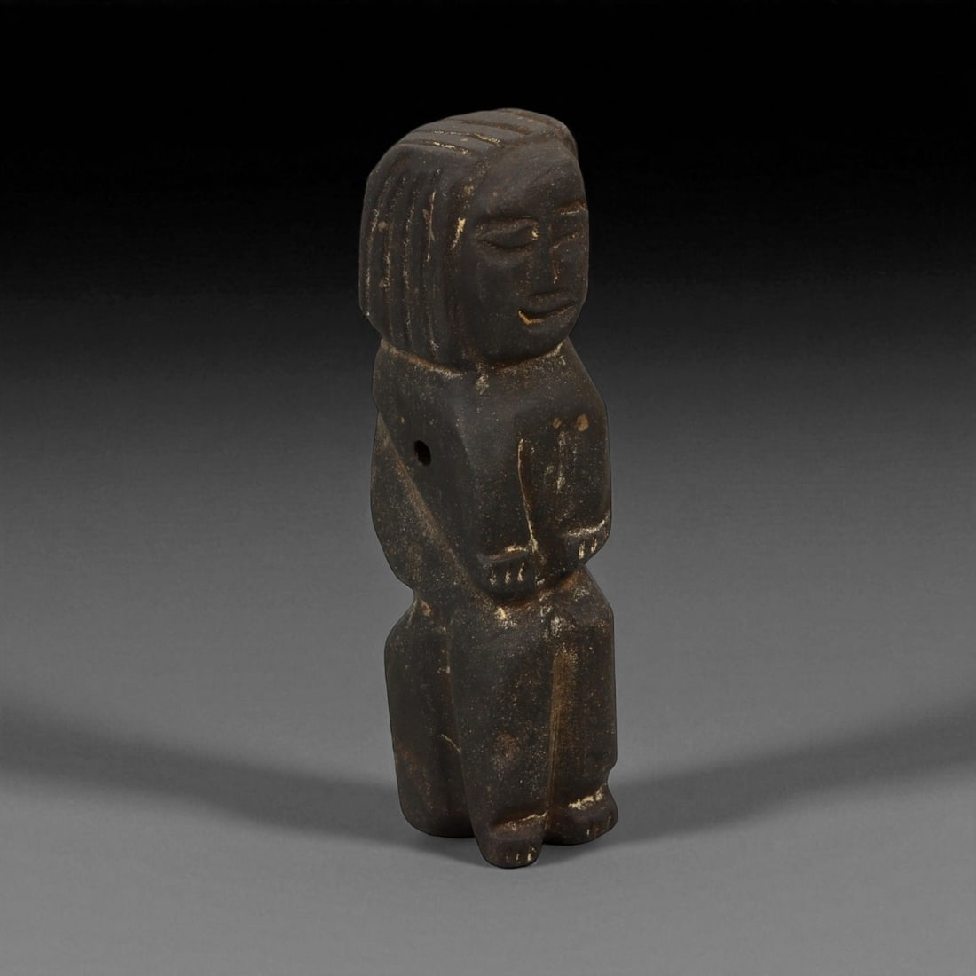 Ancient Medieval Sino-Tibetan Votive Idol, c. 12th-14th Century CE, 9.5cm: This solemn stone votive idol, carved during the 12th-14th century CE, reflects the devotional artistry of the Sino-Tibetan Buddhist tradition. The figure stands in quiet reverence, hands clasped in p