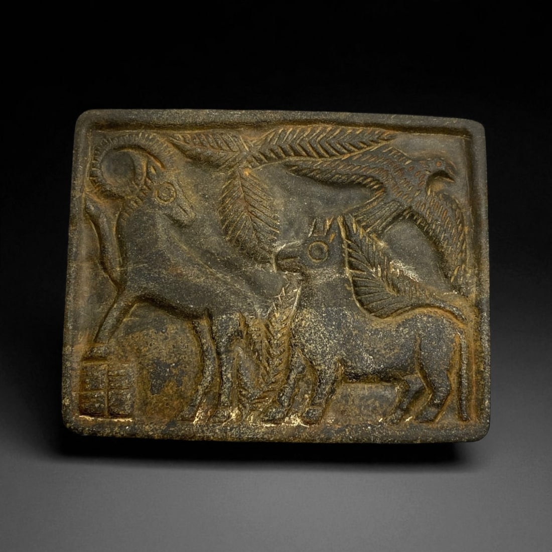 Ancient Akkadian Stone Plaque with Animal Procession, c. 23rd-21st Century BCE 10 cm: This finely carved rectangular stone plaque, measuring approximately 10 cm across, originates from the Akkadian period of Mesopotamia - one of the earliest empires in human history. The composition de