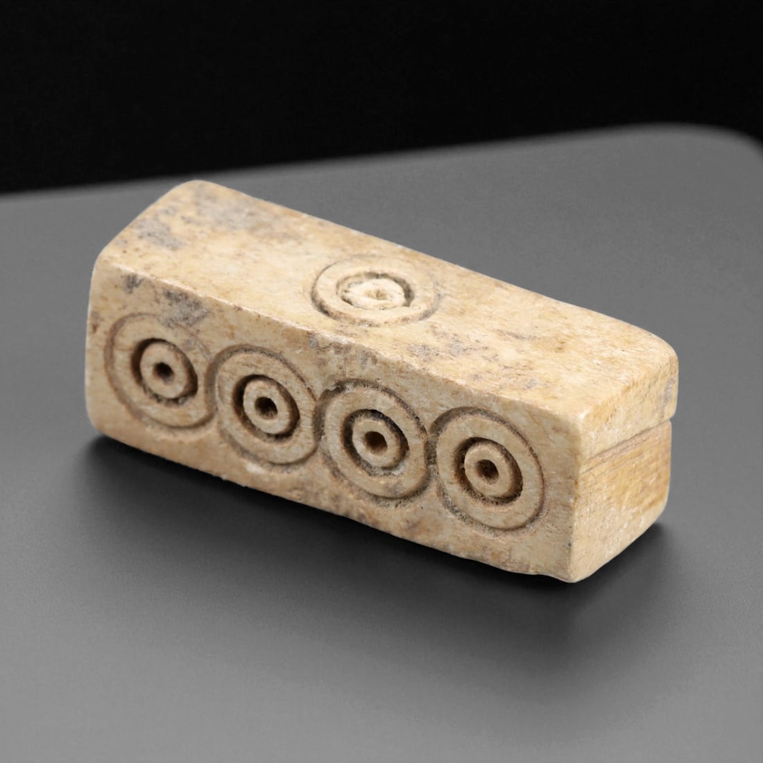 Ancient Roman Elongated Four-Sided Bone Dice, c. 2nd-4th Century CE, 3.1cm: This rare four-faced Roman gaming die, meticulously carved from bone, dates to approximately the 2nd-4th century CE. Measuring 3.1 cm in length, it represents a distinct variant of Roman dice used in 