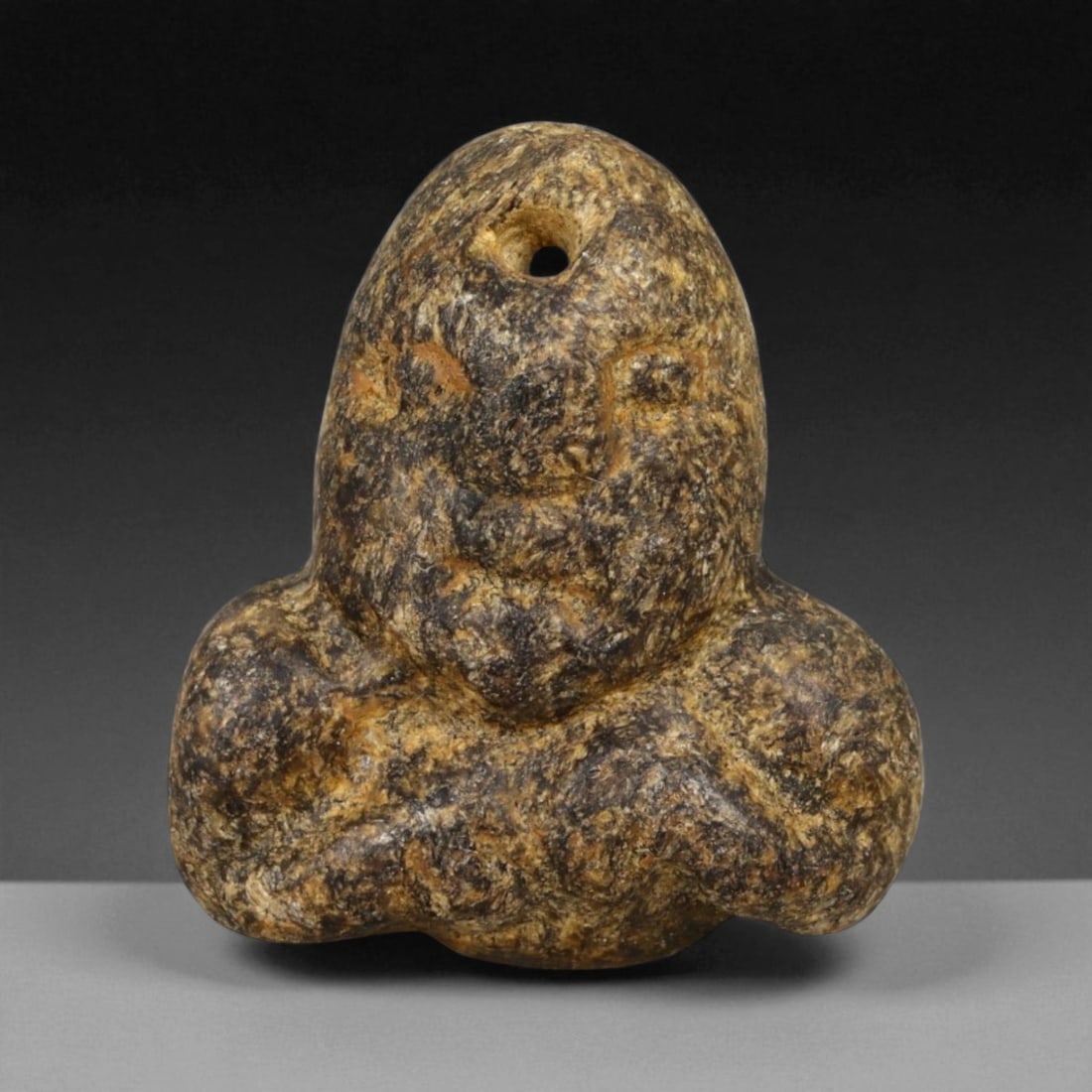 Ancient Akkadian Anthropomorphic Basalt Amulet, c. 2300-2100 BCE, 2.5cm: This small yet profoundly evocative basalt amulet dates to the Akkadian Empire, one of the earliest great Mesopotamian powers that flourished around the late 3rd millennium BCE. Carved from dense, dar