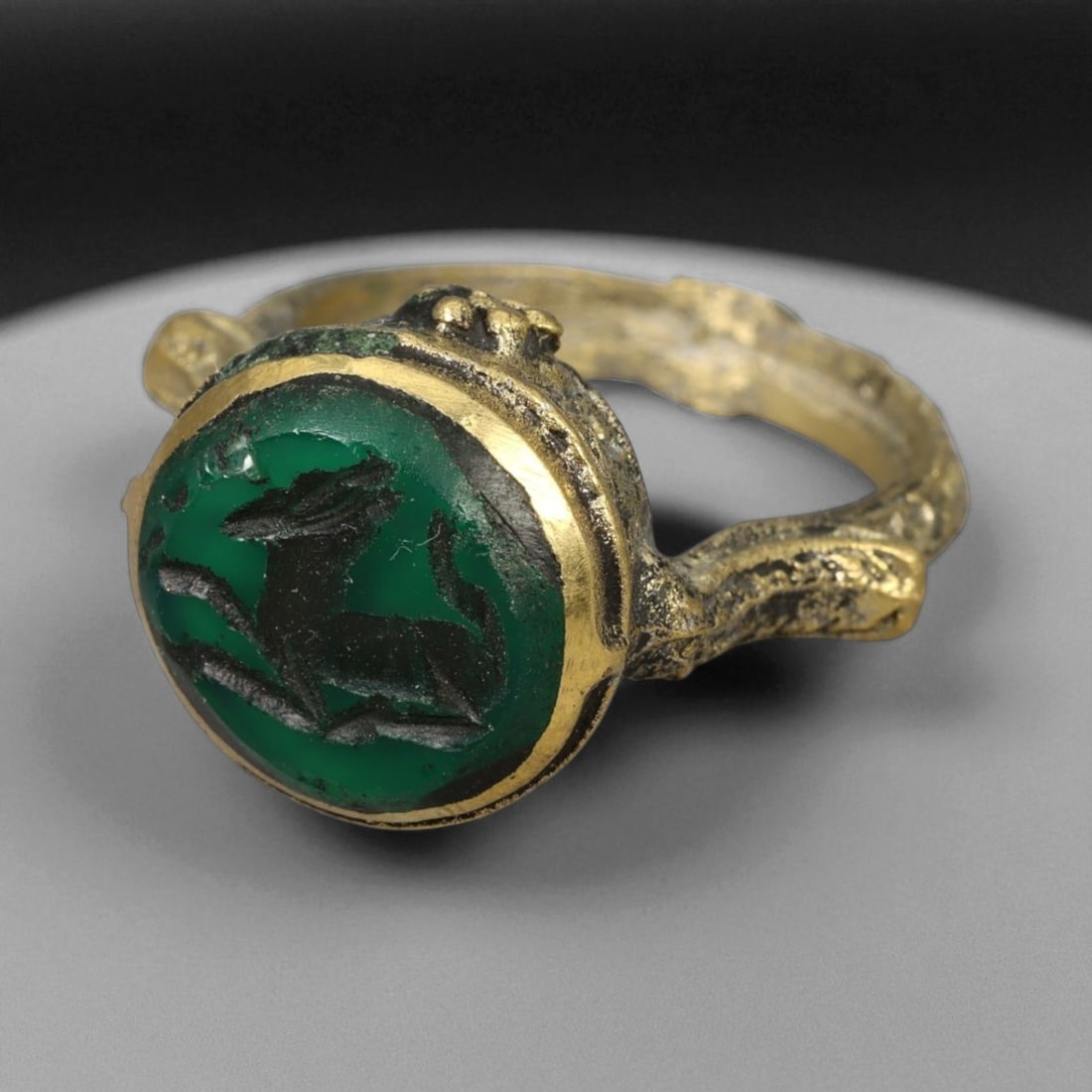 Antique Qajar Gold Gilt Intaglio Signet Ring, c. 19th-20th Century, 9.5 US: This substantial gilt ring, dating to the Qajar era of the 19th-20th century, embodies the regal aesthetic and cultural refinement of Persian jewelry traditions. The bezel is set with an engraved inta