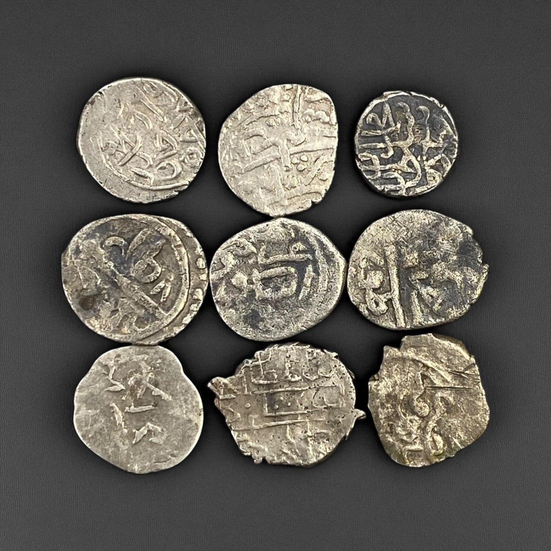 ISLAMIC STATES: Medieval Silver Dirham Lot - Trade and Faith Across the Caliphates: This remarkable lot of hand-struck silver dirhams spans centuries of Islamic civilization, each coin a tangible fragment of a world once united by faith, trade, and scholarship. Struck in radiant yet 