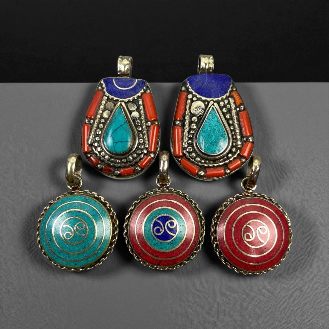 Vintage Himalayan Tribal Pendants, Lot of 5, c. 20th Century, 3-4 cm: These vintage Himalayan pendants capture the spirit and artistry of traditional jewelry from the highlands of Tibet and Nepal. Crafted with vibrant inlay work and detailed metal framing, they exemplif