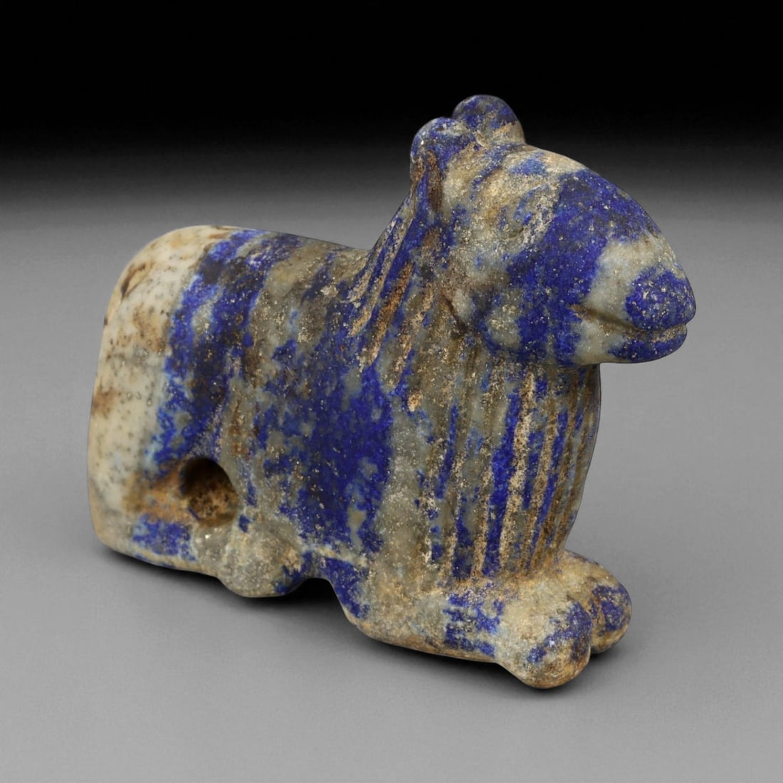 Ancient Bactrian Lapis Lazuli Lion Effigy, c. 2nd-1st Millennium BCE, L 5.5cm: This striking lapis lazuli effigy, carved in the form of a recumbent lion, originates from ancient Bactria, circa 2nd-1st millennium BCE. Sculpted from vibrant blue lapis lazuli streaked with veins of