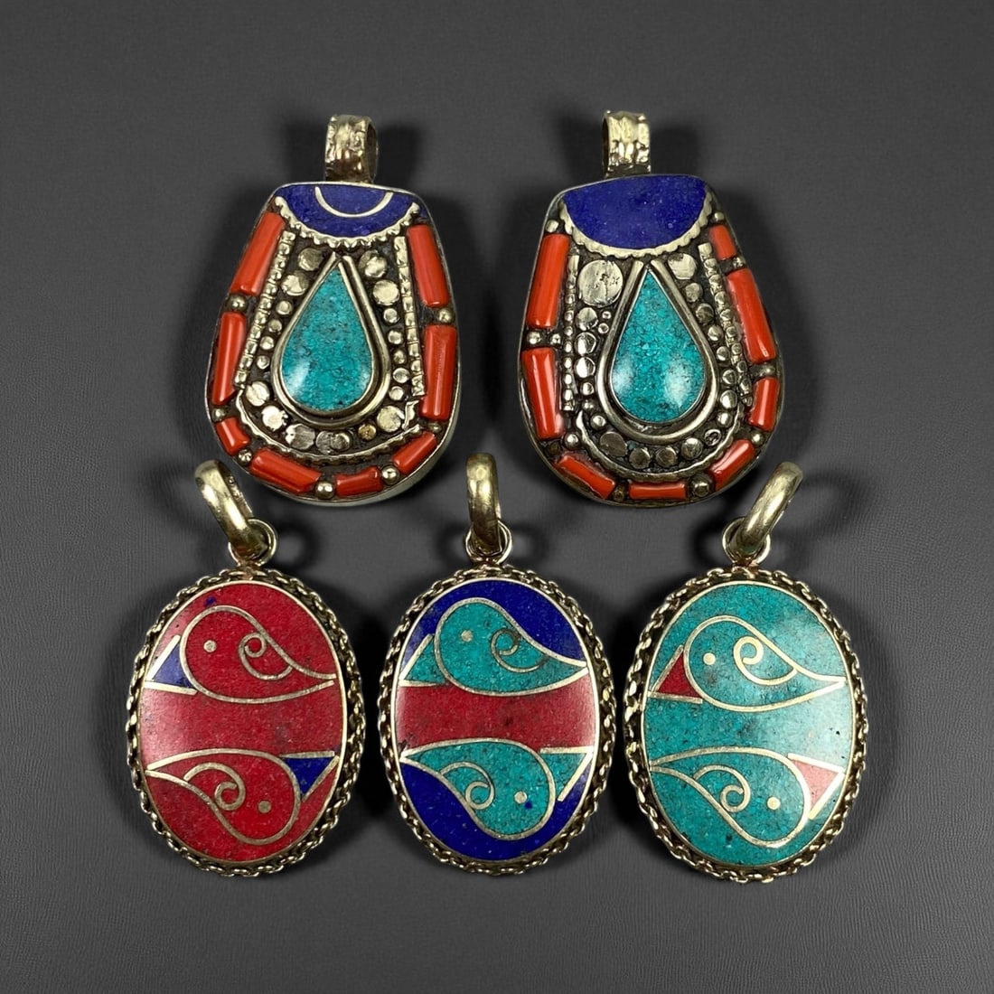 Vintage Himalayan Tribal Pendants, Lot of 5, c. 20th Century, 3-4 cm: These vintage Himalayan pendants capture the spirit and artistry of traditional jewelry from the highlands of Tibet and Nepal. Crafted with vibrant inlay work and detailed metal framing, they exemplif