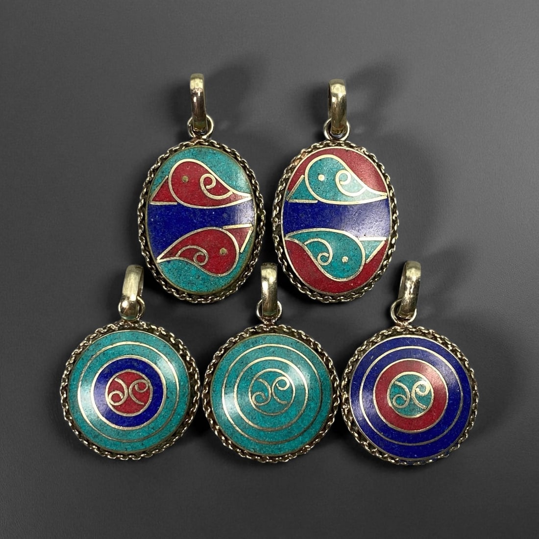 Vintage Himalayan Tribal Pendants, Lot of 5, c. 20th Century, 3-4 cm: These vintage Himalayan pendants capture the spirit and artistry of traditional jewelry from the highlands of Tibet and Nepal. Crafted with vibrant inlay work and detailed metal framing, they exemplif