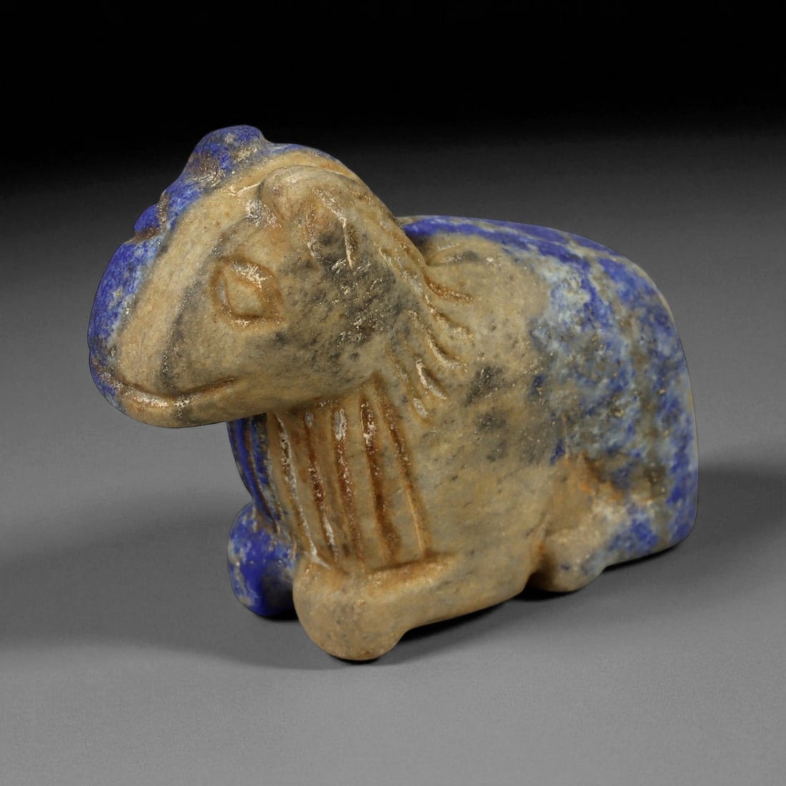 Ancient Bactrian Lapis Lazuli Lion Effigy, c. 2nd-1st Millennium BCE, L 6cm: This striking lapis lazuli effigy, carved in the form of a recumbent lion, originates from ancient Bactria, circa 2nd-1st millennium BCE. Sculpted from vibrant blue lapis lazuli streaked with veins of