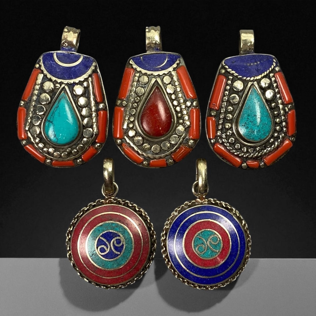 Vintage Himalayan Tribal Pendants, Lot of 5, c. 20th Century, 3-4 cm: These vintage Himalayan pendants capture the spirit and artistry of traditional jewelry from the highlands of Tibet and Nepal. Crafted with vibrant inlay work and detailed metal framing, they exemplif