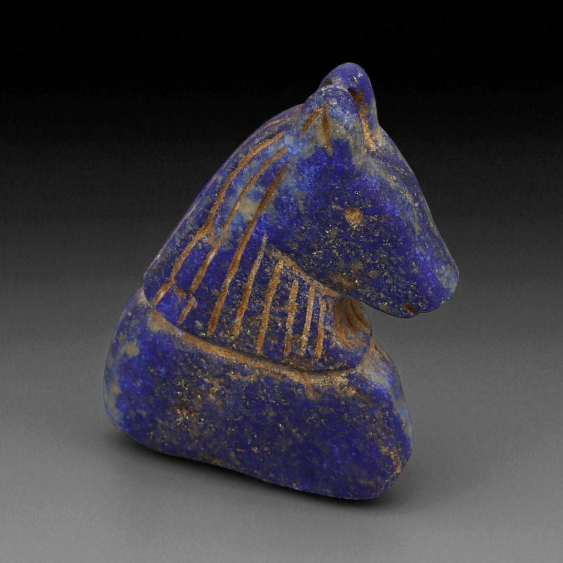 Ancient Bactrian Lapis Lazuli Horse Bust Amulet, c. 2nd-1st Millennium BCE, H 6cm: This beautifully carved lapis lazuli horse bust amulet originates from ancient Bactria, circa 2nd-1st millennium BCE - a region celebrated for its mastery of stone carving and for serving as a vital c
