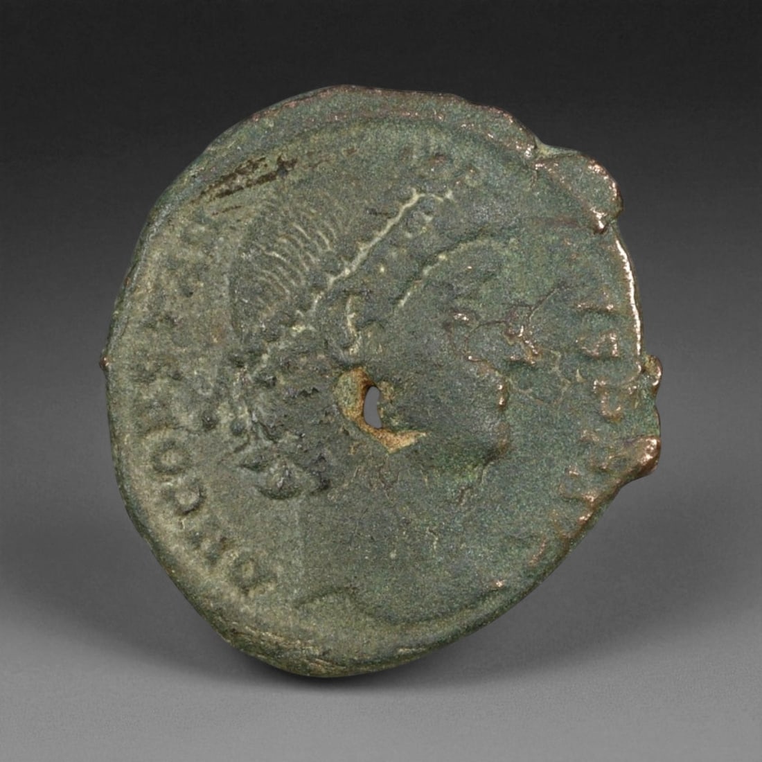 ROMAN EMPIRE: Imperial Authority - Bronze Coin, c. 1st-3rd Century AD, 15mm: Struck during the turbulent decades of the later Roman Empire, this 19mm bronze coin reflects the enduring symbolism of imperial control amidst crisis. Its compact yet deliberate design likely feature
