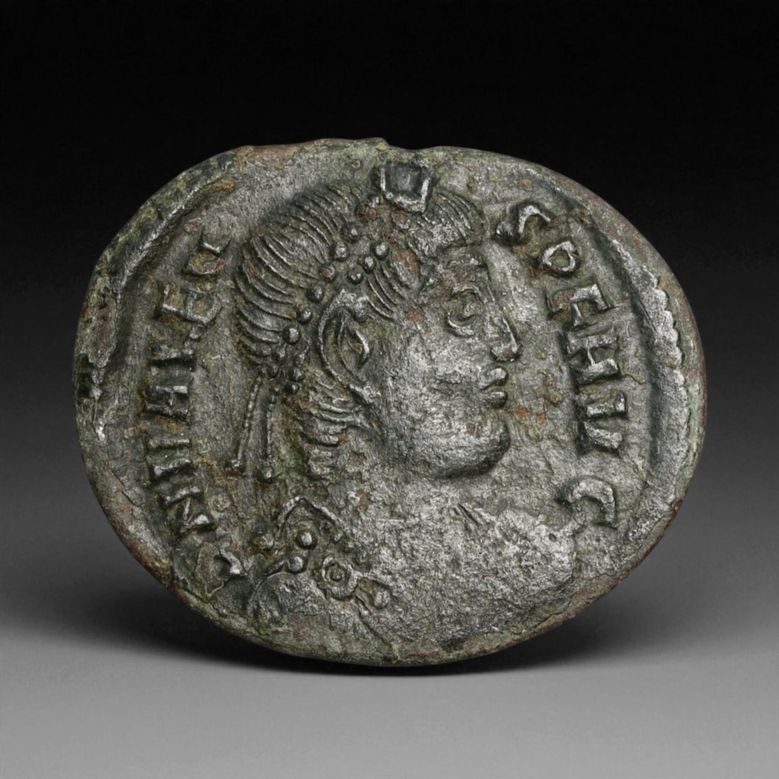 ROMAN EMPIRE: Imperial Authority - Bronze Coin, c. 1st-3rd Century AD, 19mm: Struck during the turbulent decades of the later Roman Empire, this 19mm bronze coin reflects the enduring symbolism of imperial control amidst crisis. Its compact yet deliberate design likely feature