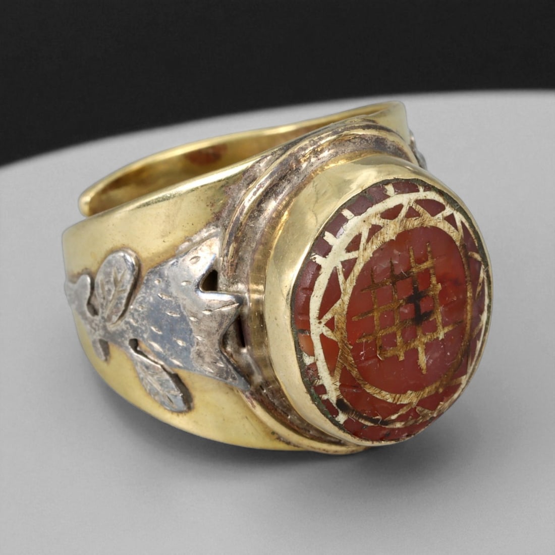 Antique Etched Carnelian Silver Gilt Ring, Early Stone, 20th Century Mount: This striking ring features an antique etched carnelian, its surface decorated with traditional linear motifs filled with gold, a style associated with ancient talismanic seals and amulets. The carnel