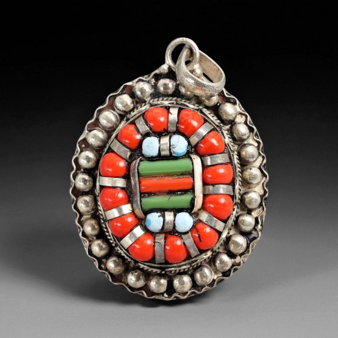 Vintage Himalayan Tibetan Coral Turquoise Glass Silver Pendant, 20th Century, 5.5cm: This vintage Himalayan Tibetan pendant presents a vivid display of color and craftsmanship, featuring a central arrangement of coral, turquoise, and green glass framed by a border of raised silver gra
